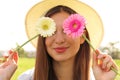 Girl playing with fresh colorful flowers hiding her eyes. Enjoying spring time outdoor Royalty Free Stock Photo