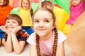 Girl playing with friends hiding under parachute Royalty Free Stock Photo