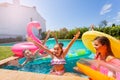 Girl playing games with friends during pool party