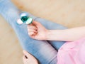 Girl playing with a glossy light colourful hand fidget spinner toy Royalty Free Stock Photo