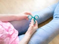 Girl playing with a glossy light colourful hand fidget spinner toy Royalty Free Stock Photo