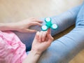 Girl playing with a glossy light colourful hand fidget spinner toy Royalty Free Stock Photo