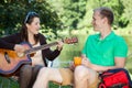 Girl playing guitar on a camping