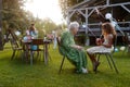 Girl playing on guitar for her grandmother at garden party. Love and closeness between grandparent and grandchild.