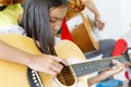 Girl Playing Guitar in Music Classroom