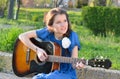 Girl playing guitar in nature Royalty Free Stock Photo