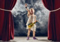 Girl playing guitar on stage Royalty Free Stock Photo