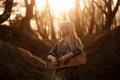 Girl playing the harp at sunset in the forest Royalty Free Stock Photo