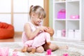 Girl playing with her baby-doll Royalty Free Stock Photo