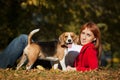 Girl playing with her dog in autumn park