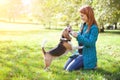 Girl playing with her dog in autumn park Royalty Free Stock Photo