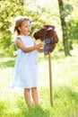 Girl Playing With Hobby Horse In Summer Field Royalty Free Stock Photo