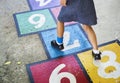 Girl playing hopscotch on a street