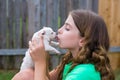 Girl playing kissing puppy chihuahua pet dog Royalty Free Stock Photo