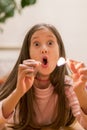 Girl playing with matches. Dangerous situation at home. A small child plays with matches, a fire, a fire flares up Royalty Free Stock Photo