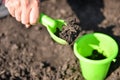 Girl playing in the mud with green toys Royalty Free Stock Photo