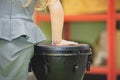 The girl are playing a musical instrument. African djembe Meinl