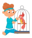 Girl playing with parrot. Kid speaking with bird in cage