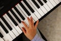 The girl playing the piano, close-up piano, white and black keyboard. Close-up portrait girl playing a melody on the Royalty Free Stock Photo