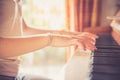 Girl is playing piano at home, high angle view, blurry background