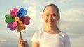 Girl playing pinwheel park in slow motion. Happy child playing having fun pinwheel. Happiness vacation childhood