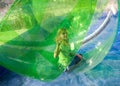 Girl playing in a plastic ball on water