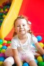 Girl playing on the playground, in the children`s maze with ball Royalty Free Stock Photo