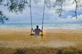 Girl playing rope swing on an empty beach, Koh Rong Saleom, Cambodia