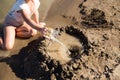 Girl playing in the sand on the lake Royalty Free Stock Photo