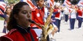 Girl playing saxophone in a march band