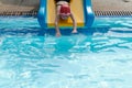 a girl playing slider in swimmimg pool Royalty Free Stock Photo