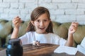 Girl playing with small figures sitting on soft