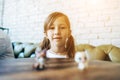 Girl playing with small figures sitting on soft Royalty Free Stock Photo