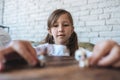 Girl playing with small figures sitting on soft