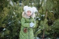 Girl playing snowballs. Funny little girl having fun in winter park. making snowballs happy child girl. winter girl throwing Royalty Free Stock Photo