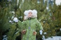 Girl playing snowballs. Funny little girl having fun in winter park. making snowballs happy child girl. winter girl throwing Royalty Free Stock Photo