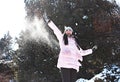 A girl playing snowballs in winter in parck Royalty Free Stock Photo