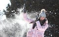 A girl playing snowballs in winter in parck Royalty Free Stock Photo