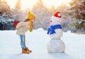 Girl playing with a snowman Royalty Free Stock Photo