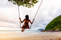 Girl playing the swing on beach Royalty Free Stock Photo