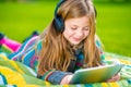 Girl Playing Tablet in a Park Royalty Free Stock Photo