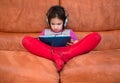 Girl playing tablet pc with headphones