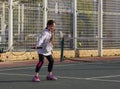 Girl playing tennis on the court