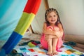 Girl playing in tent. Child camping at campground outdoor. Having fun outside.