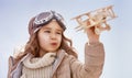 Girl playing with toy airplane