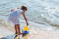 Girl playing with toy sailboat at the lake Royalty Free Stock Photo