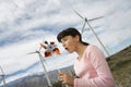 Girl Playing With Toy Windmill At Wind Farm Royalty Free Stock Photo