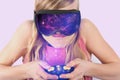 Girl playing VR space game using virtual reality glasses and a c Royalty Free Stock Photo