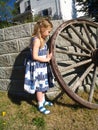 Girl playing with wagon wheel Royalty Free Stock Photo