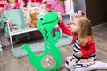 Girl plays with a blue piggy Bank Royalty Free Stock Photo